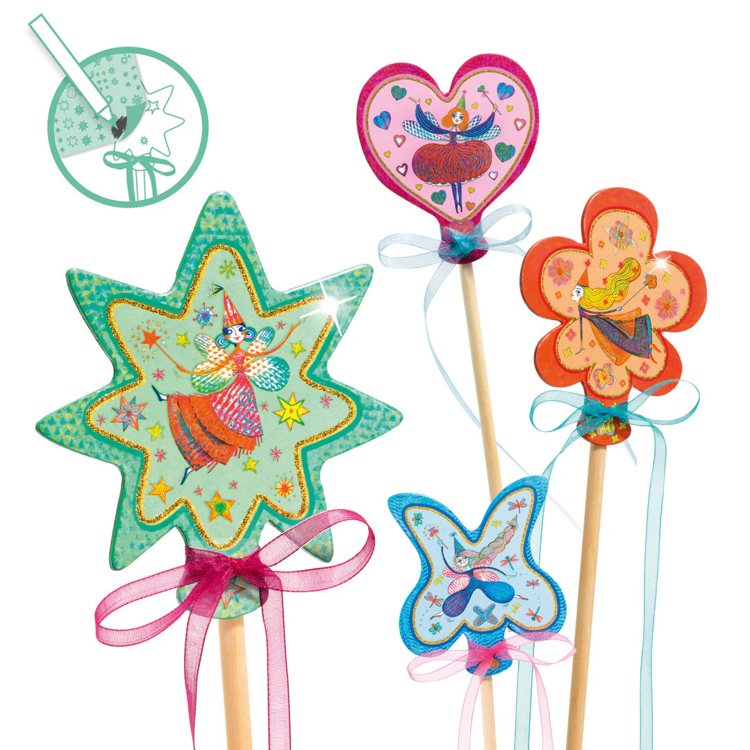 Colorful fairy-themed wands on sticks with decorative elements on a white background