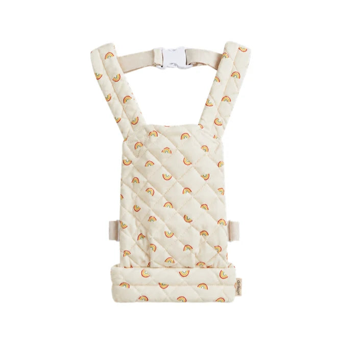 A quilted doll carrier with a cream-colored fabric and a repeating pattern of small orange and yellow rainbows, shown against a plain white background.