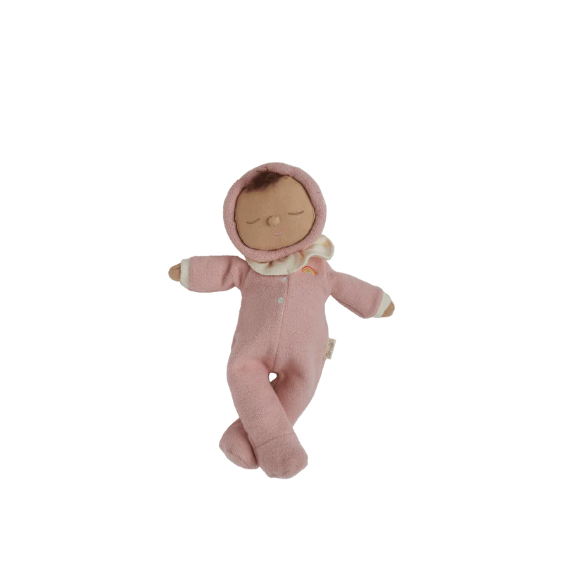 Two plush toys, one pink and one red, on a wicker stool and floor with wooden blocks.