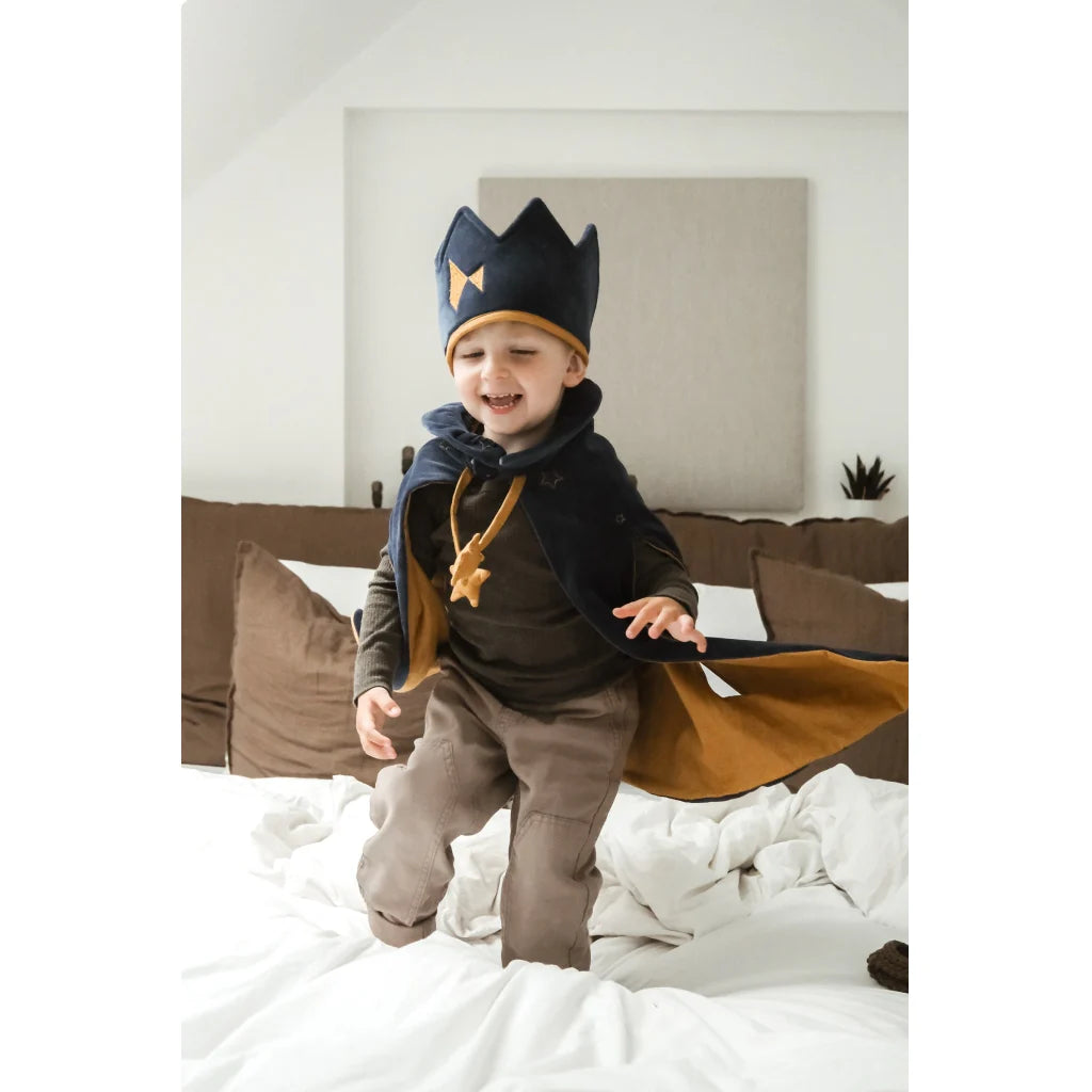 Navy blue and gold children's costume with a cape and crown on a white background