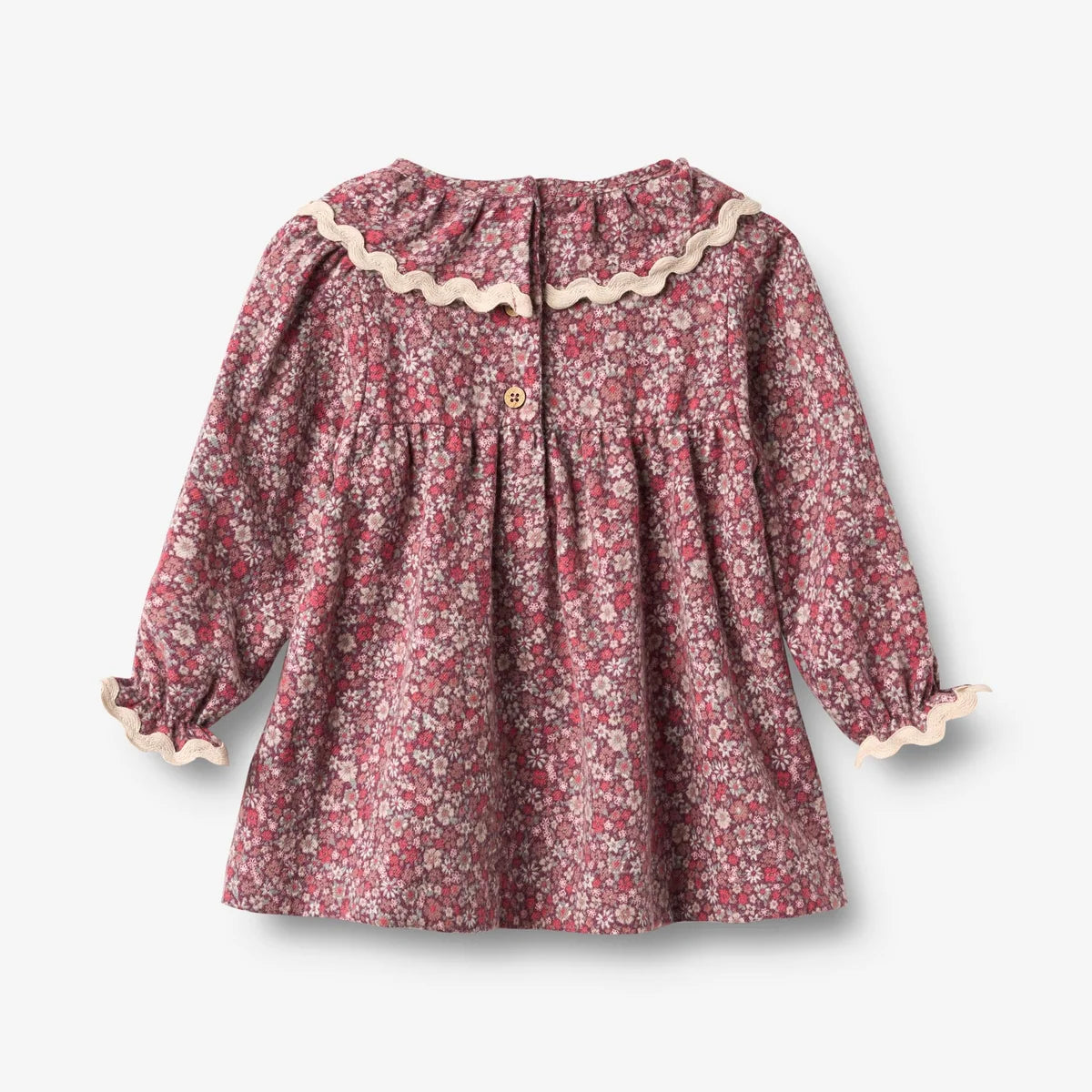 A long-sleeve dress with a dense pink, red, and white floral print, featuring a ruffled cream collar, buttoned front, and ruffled cuffs, shown flat against a light gray background.