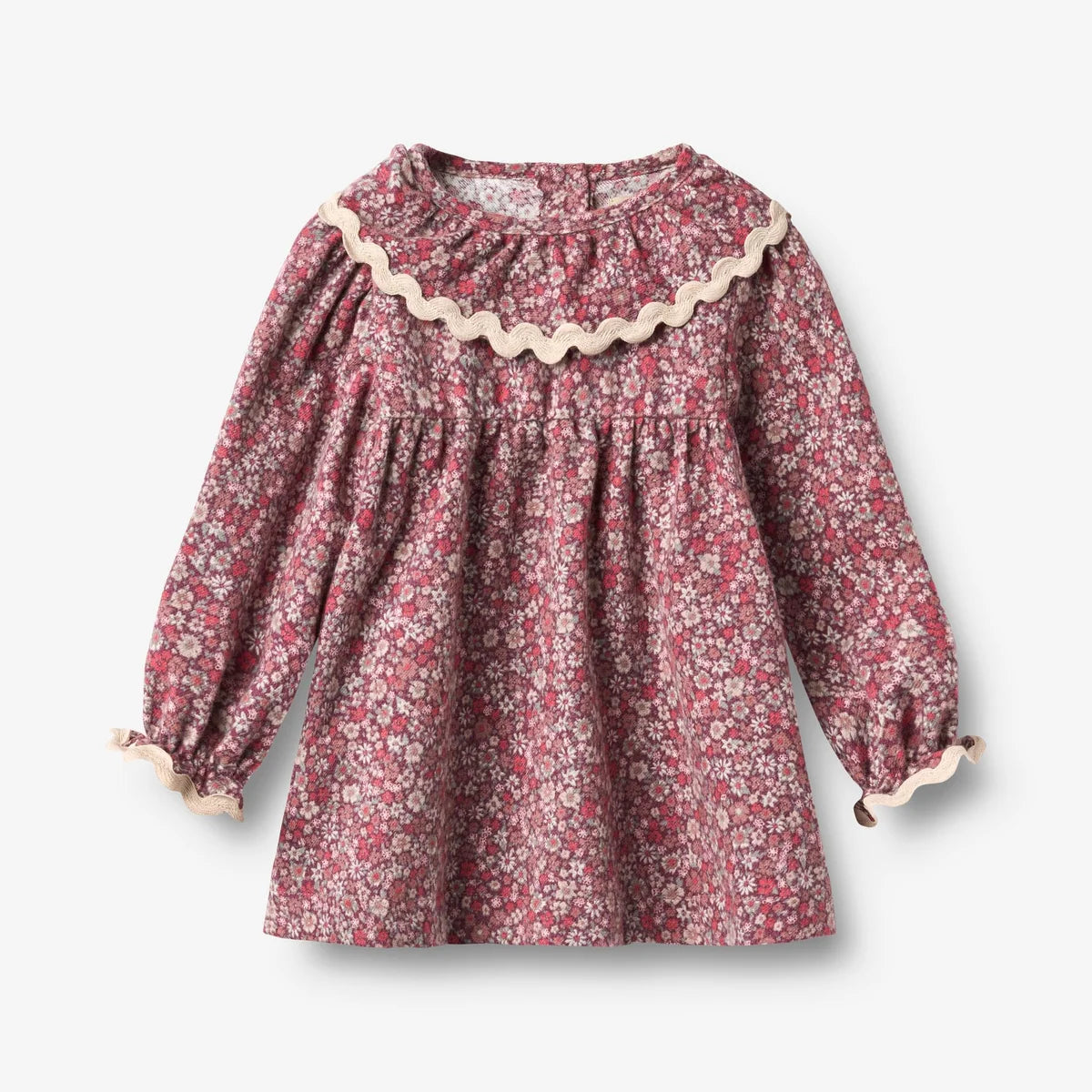 A long-sleeve dress featuring a dense pink and white floral print, a smocked bodice, and a large ruffled collar with beige trim.