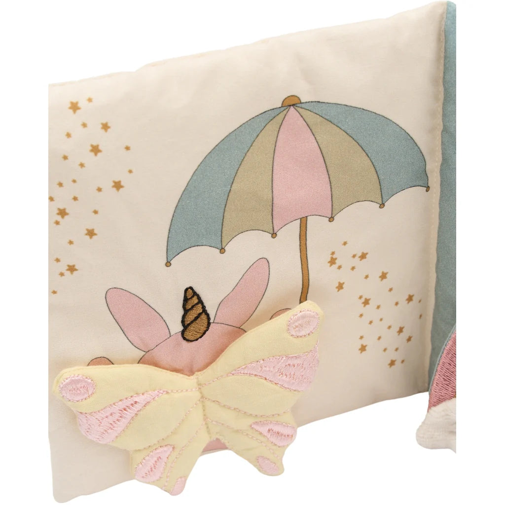 Decorative book with a butterfly and umbrella design on a beige background