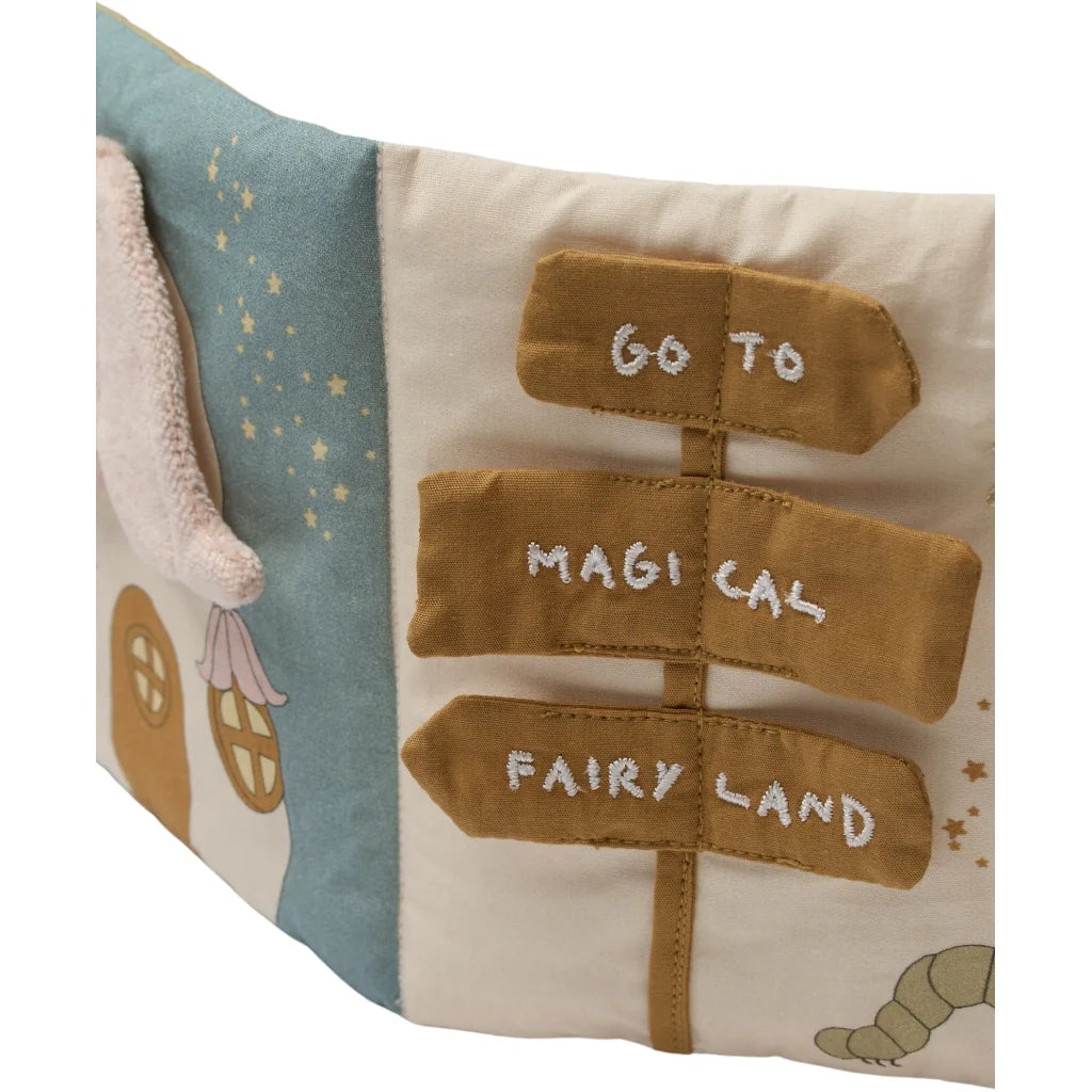 Children's book with fabric illustrations and text on a white background