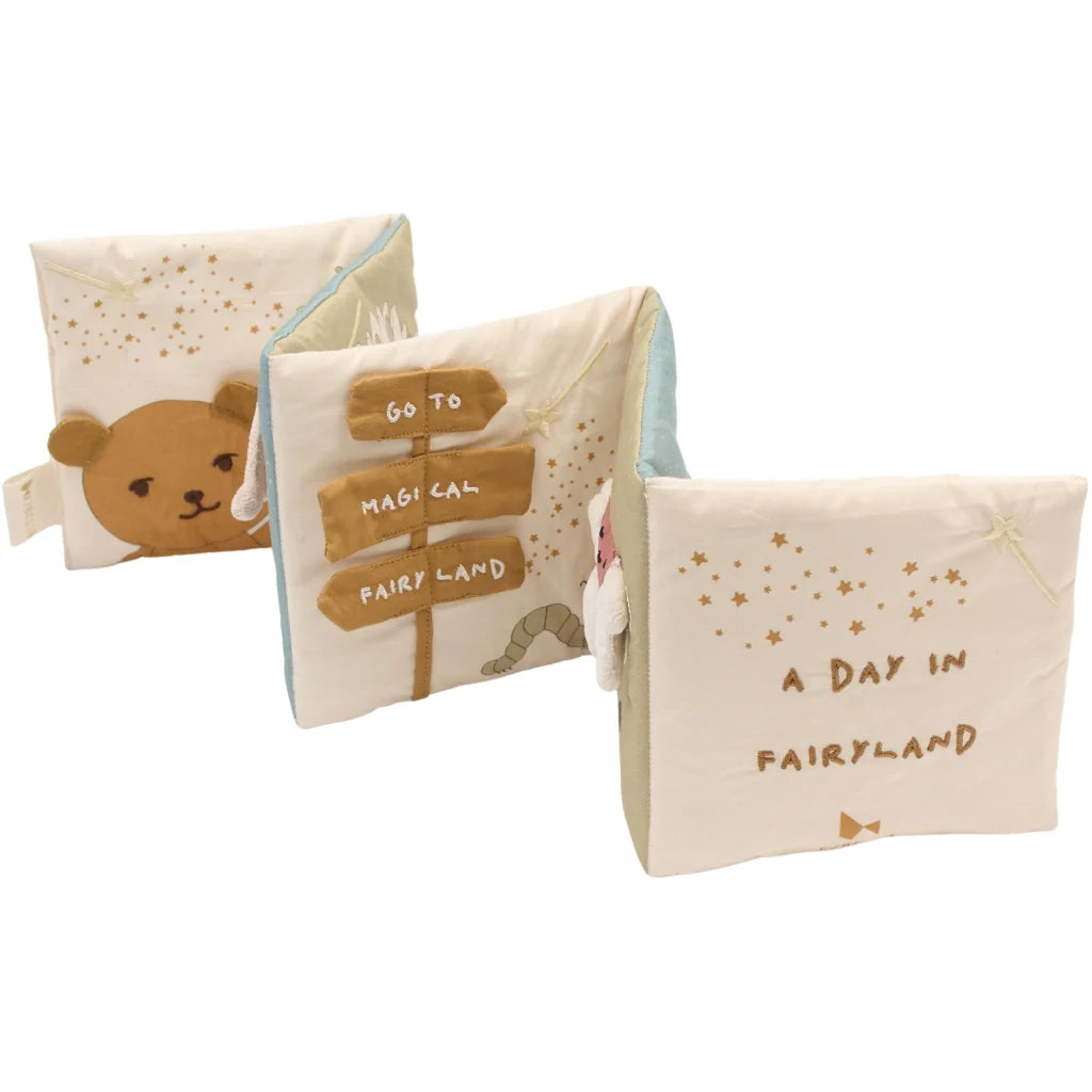 Children's soft book with bear illustration and text on a white background