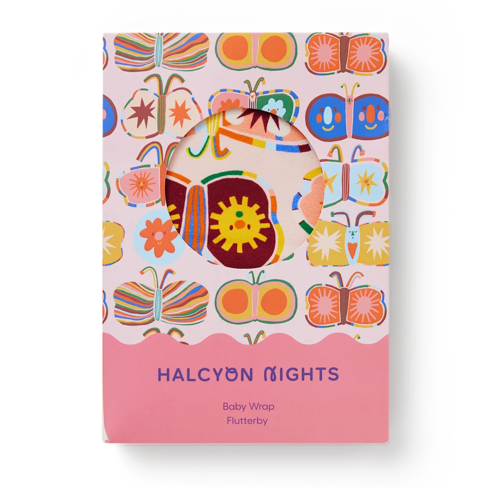 A baby wrap featuring a colorful butterfly pattern on a light pink background, with a solid pink bottom section that reads 'HALCYON NIGHTS Baby Wrap Flutterby'.