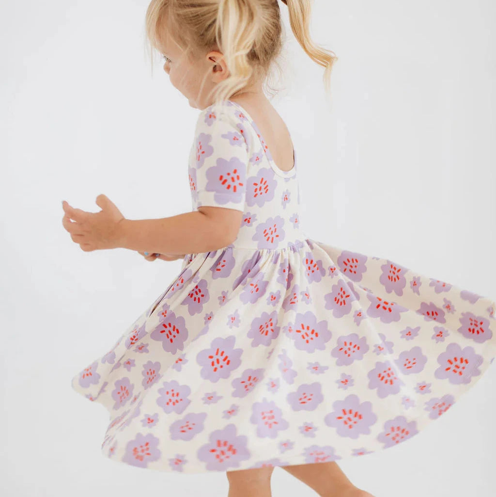 Young girl wearing a floral dress on a white background