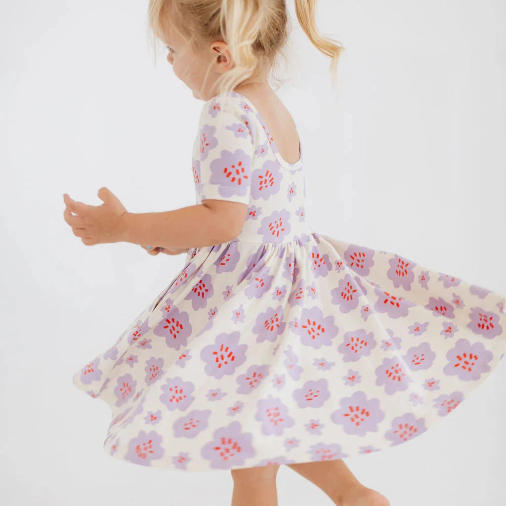 Young girl wearing a floral dress on a white background