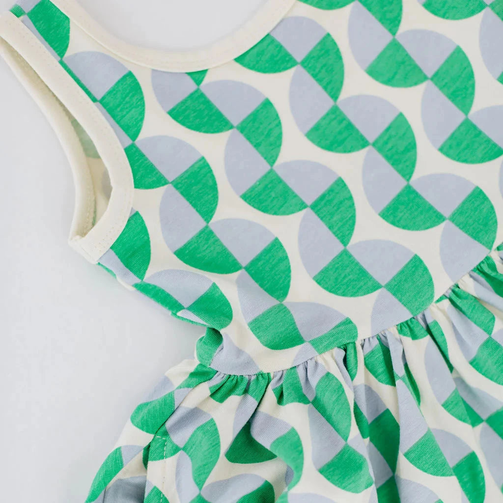 Green and white patterned dress on a white background