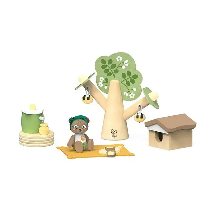 Children's toy set with a tree, teddy bear, and beehive  on a white background