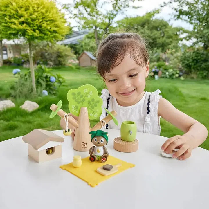 Child playing with toys on a table outdoors