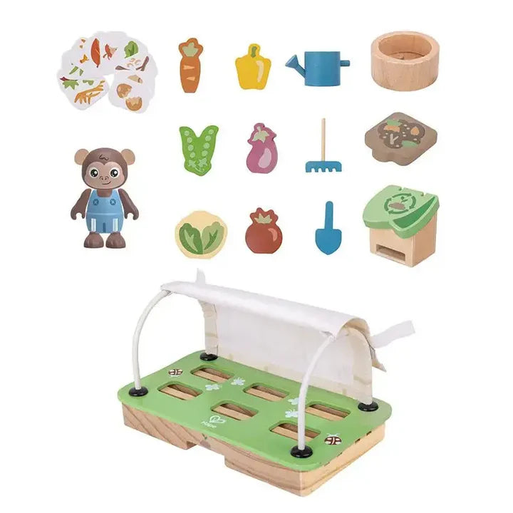 Set of wooden toys including a farm scene, animals, and gardening tools on a white background