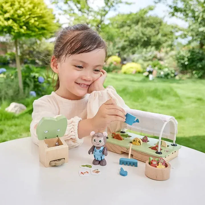 Child playing with a toy set outdoors on a sunny day