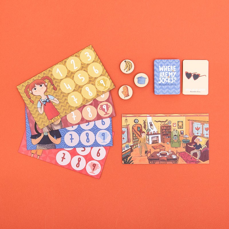 Collection of board game materials on an orange background