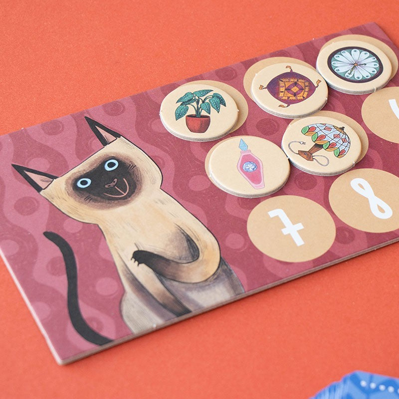 Card with a cat illustration and various symbols on a red background
