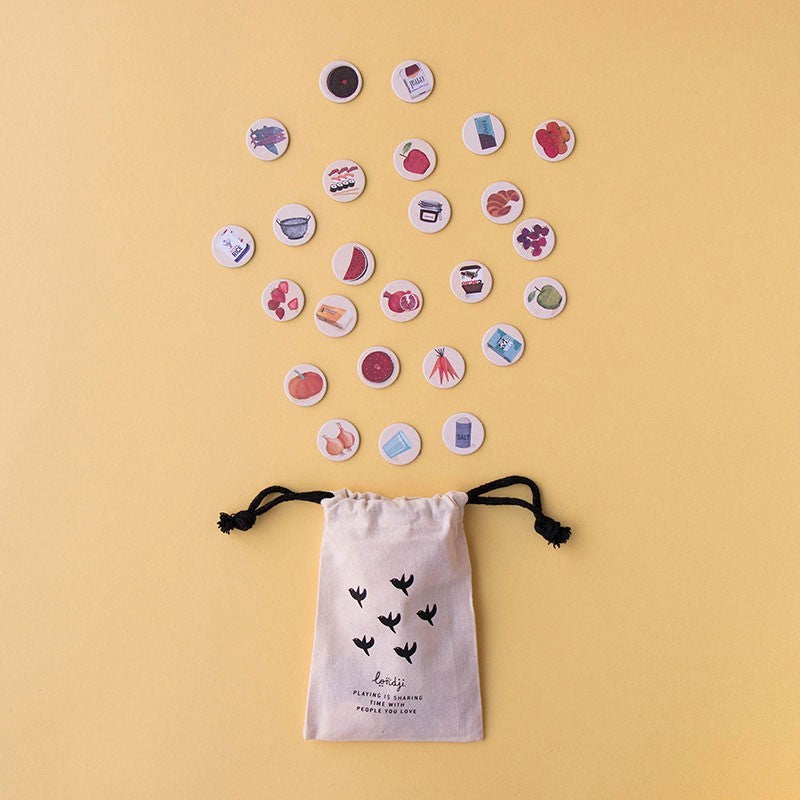 Set of colorful round tokens on a yellow background with a drawstring bag featuring bird designs.