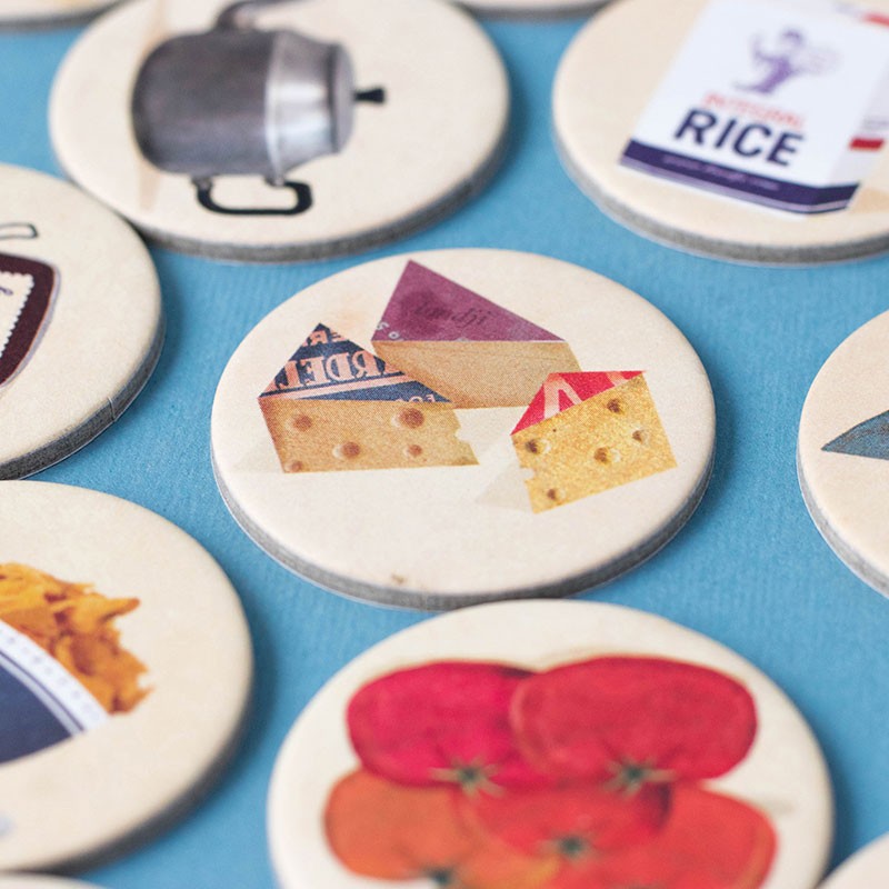 Set of round game pieces with food illustrations on a blue background