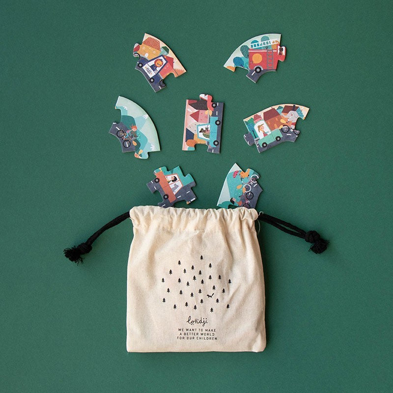 Colorful puzzle pieces on a green background with a drawstring bag.