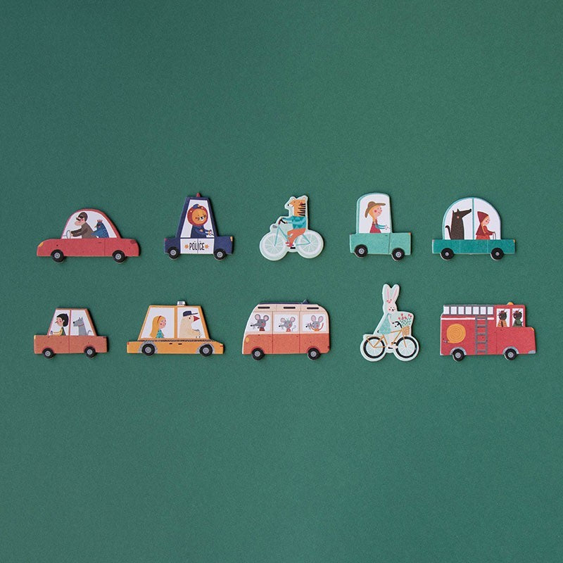 Set of colorful toy vehicle figures on a green background
