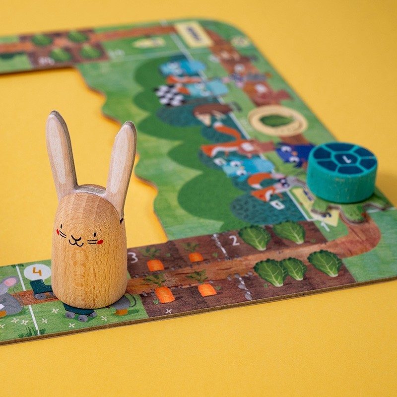 Wooden rabbit figure on a colorful board game with a yellow background