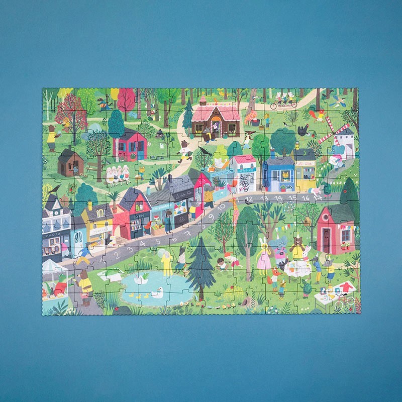 Colorful children's puzzle of a village scene on a blue background