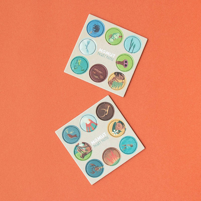 Two sheets of colorful cut outs on an orange background