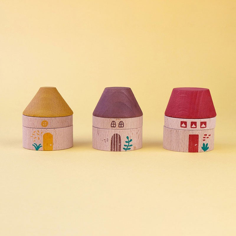 Three colorful house-shaped houses on a yellow background