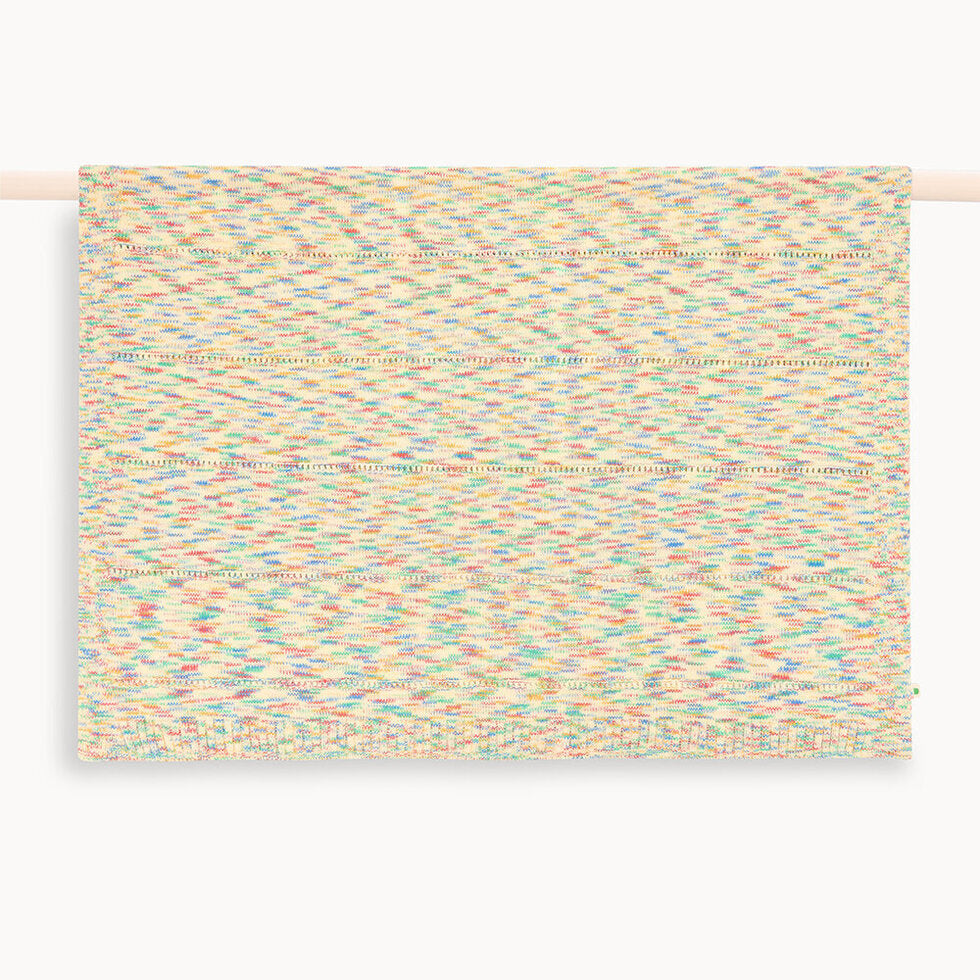 Multicolored woven baby blanket on a white background