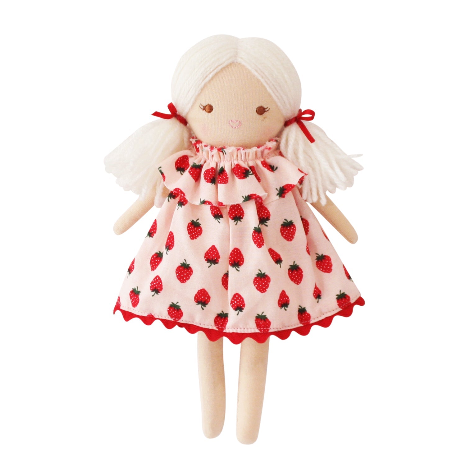 Doll with strawberry-patterned dress on a white background