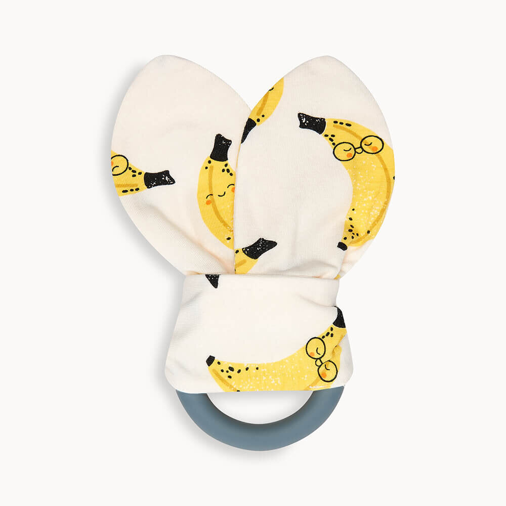 Teething ring with banana-patterned ears on a white background