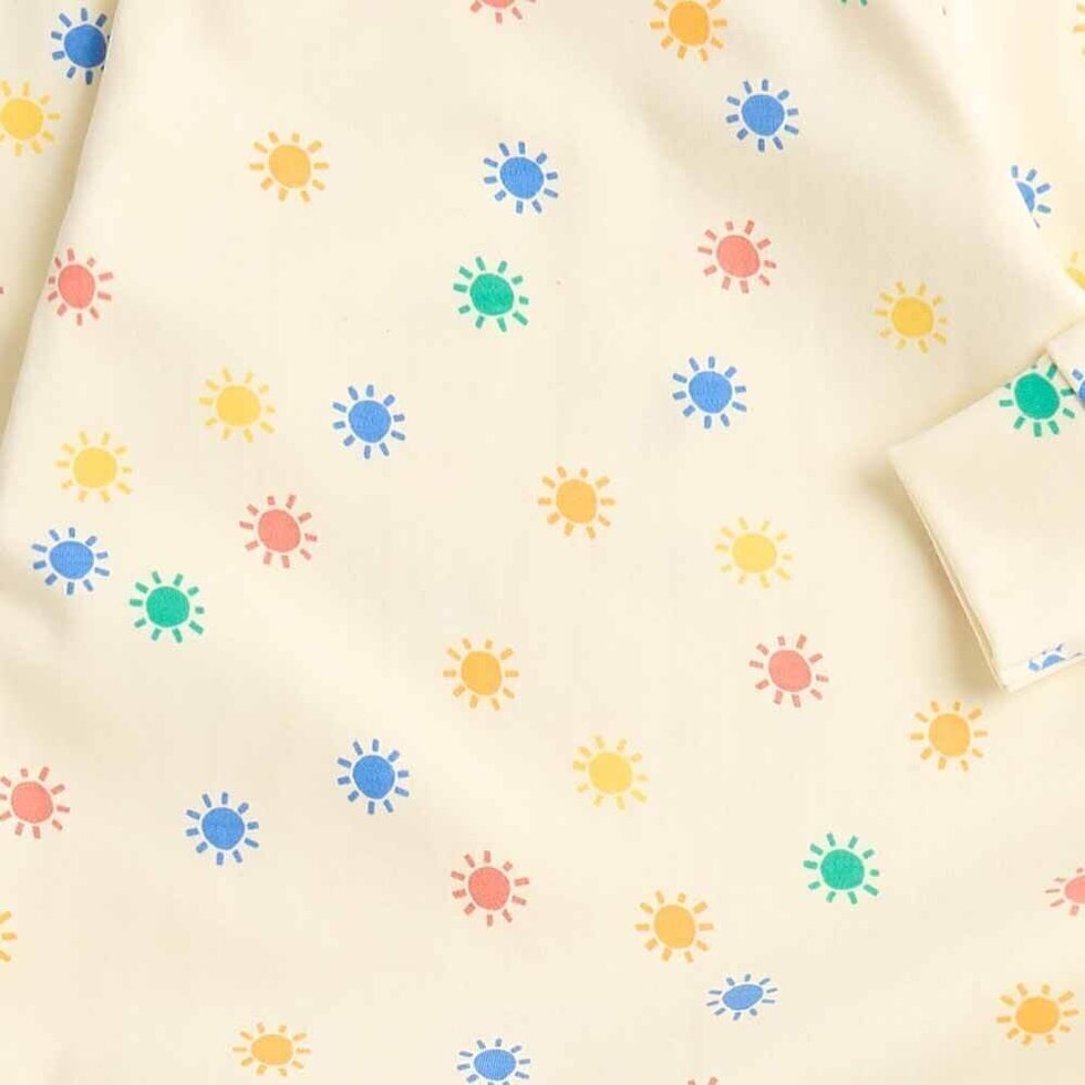 Fabric with colorful sun pattern on a beige background