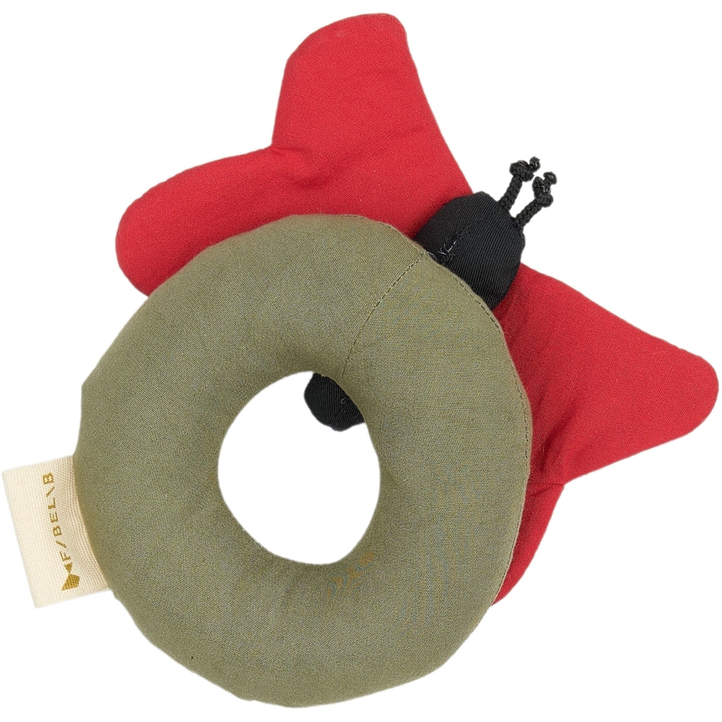Red and green ladybug-shaped toy with a visible brand tag on a white background