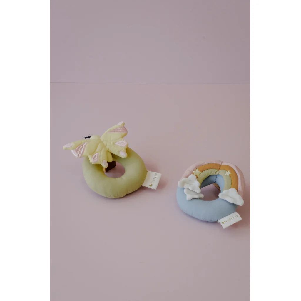 Two soft toy rings on a pink background