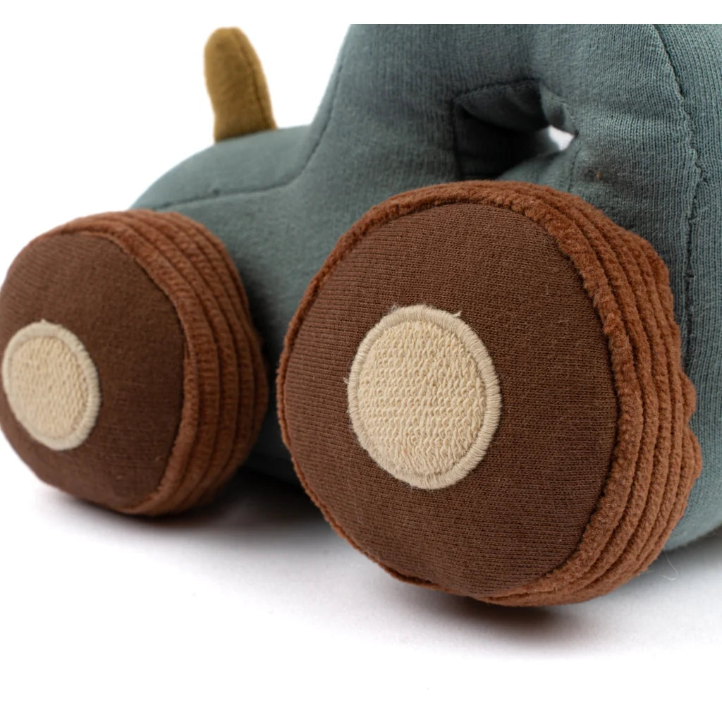 Close-up of a plush toy with brown wheels on a white background