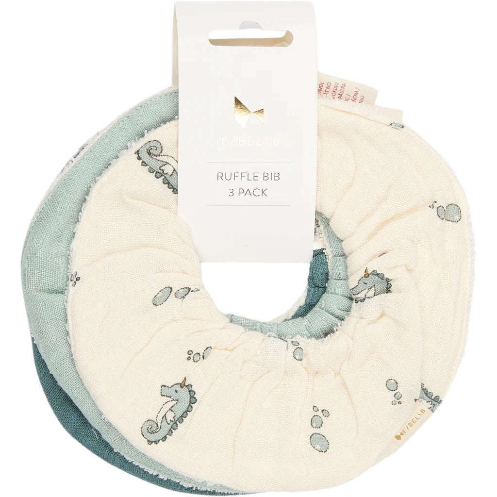 Three fabric bibs  in teal, mint, and beige on a white background