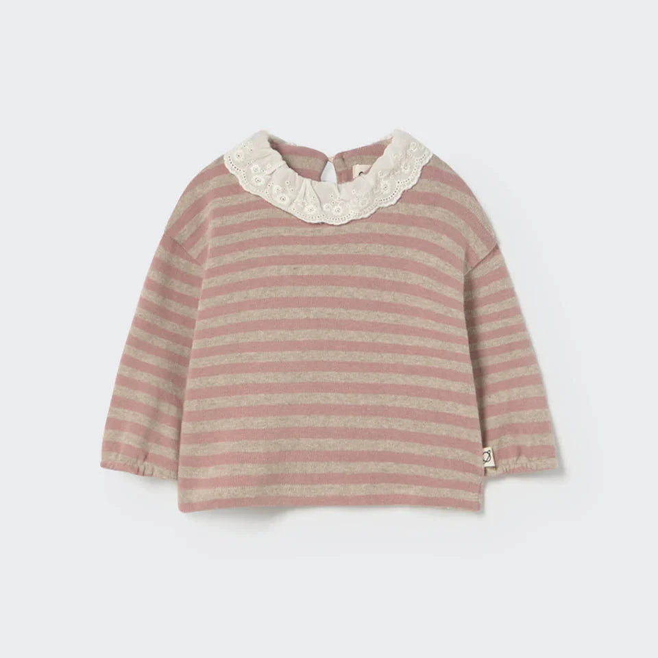Striped baby sweater with lace collar on a white background