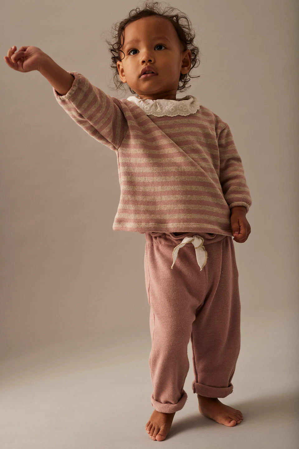 Pink baby pants with drawstring on a white background