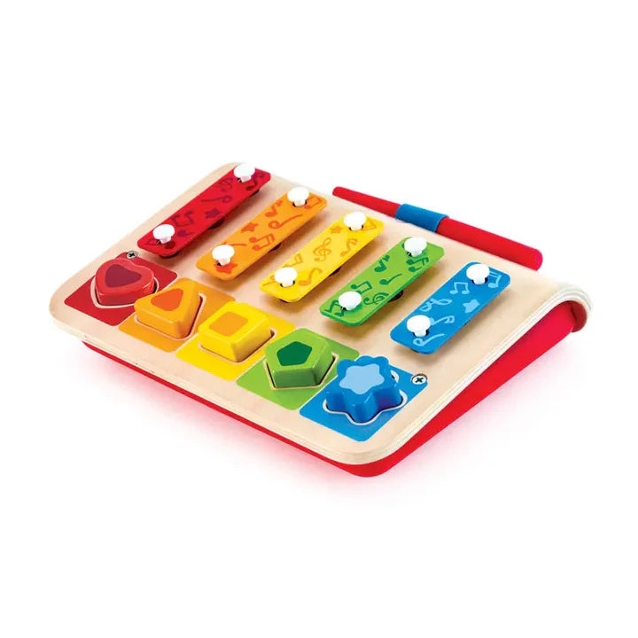 Colorful wooden toy piano with different shaped keys on a white background