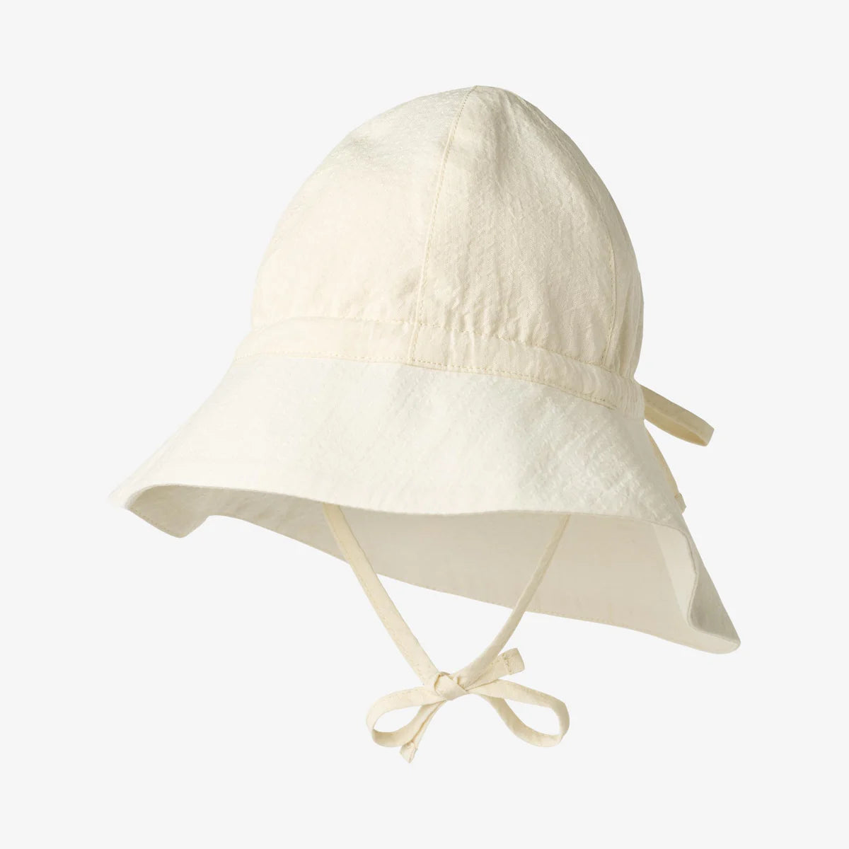 Beige baby sun hat with ties on a light gray background