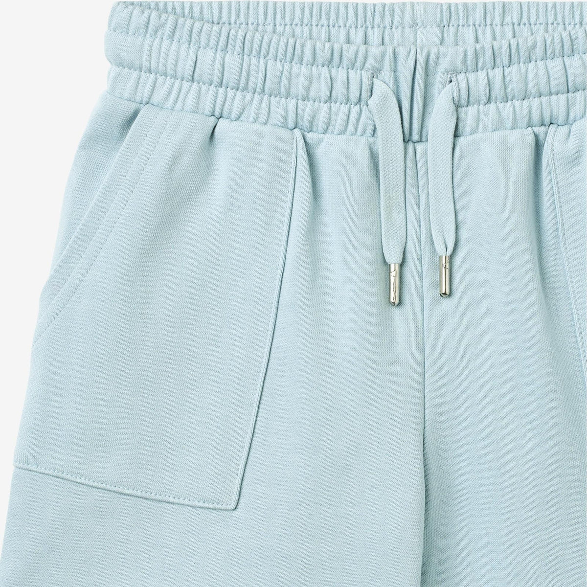 Light blue sweatpants with drawstring on a white background