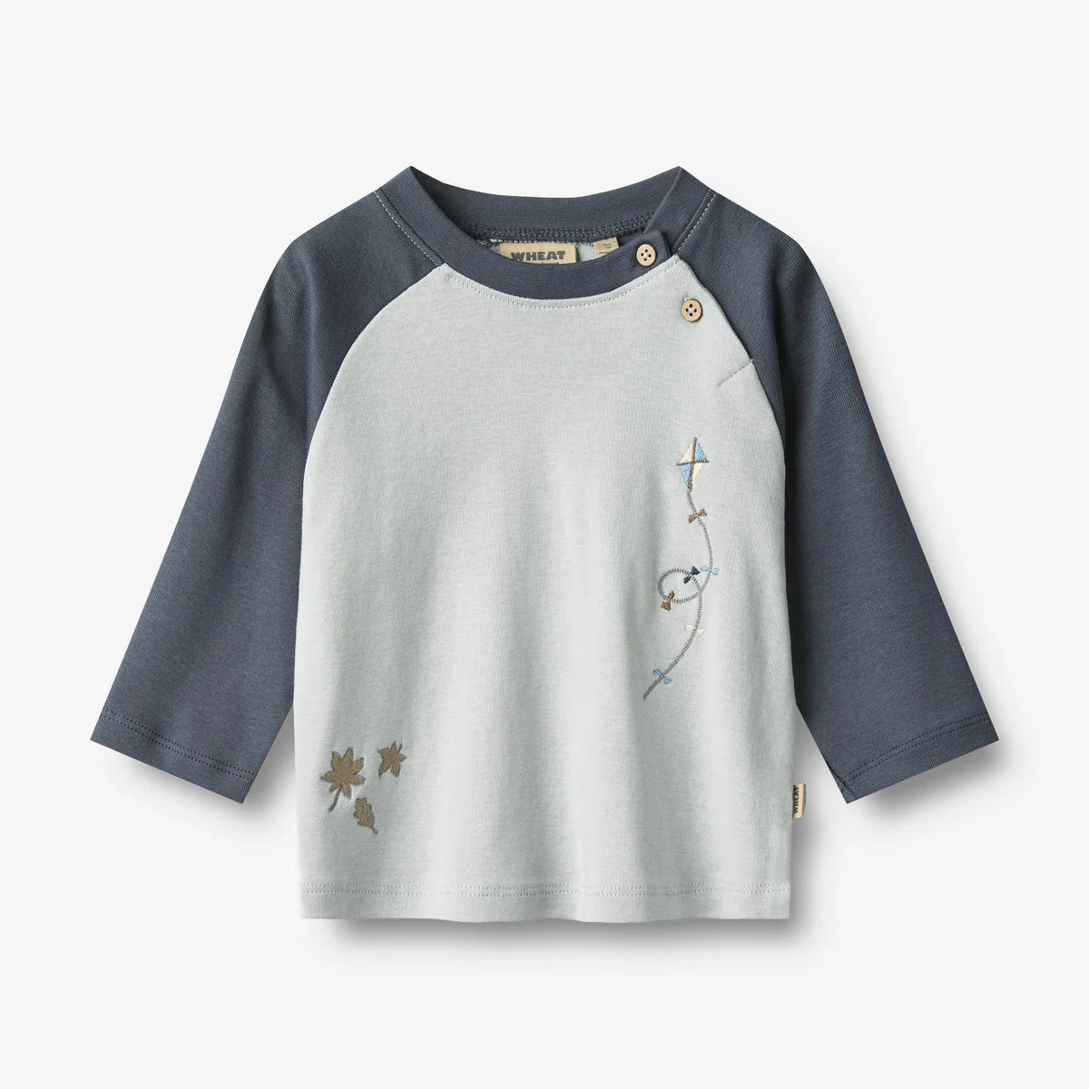 A children's long-sleeve raglan top featuring a light gray body and slate blue-gray sleeves, with delicate embroidered details on the chest.
