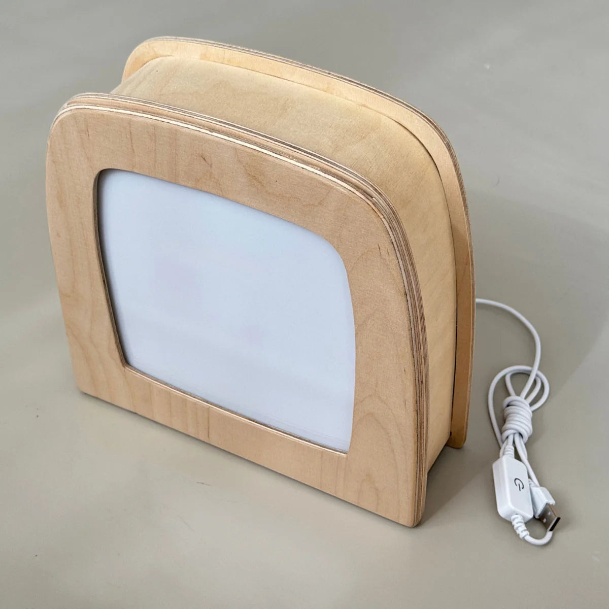 Wooden l lamp with a white interior on a gray background