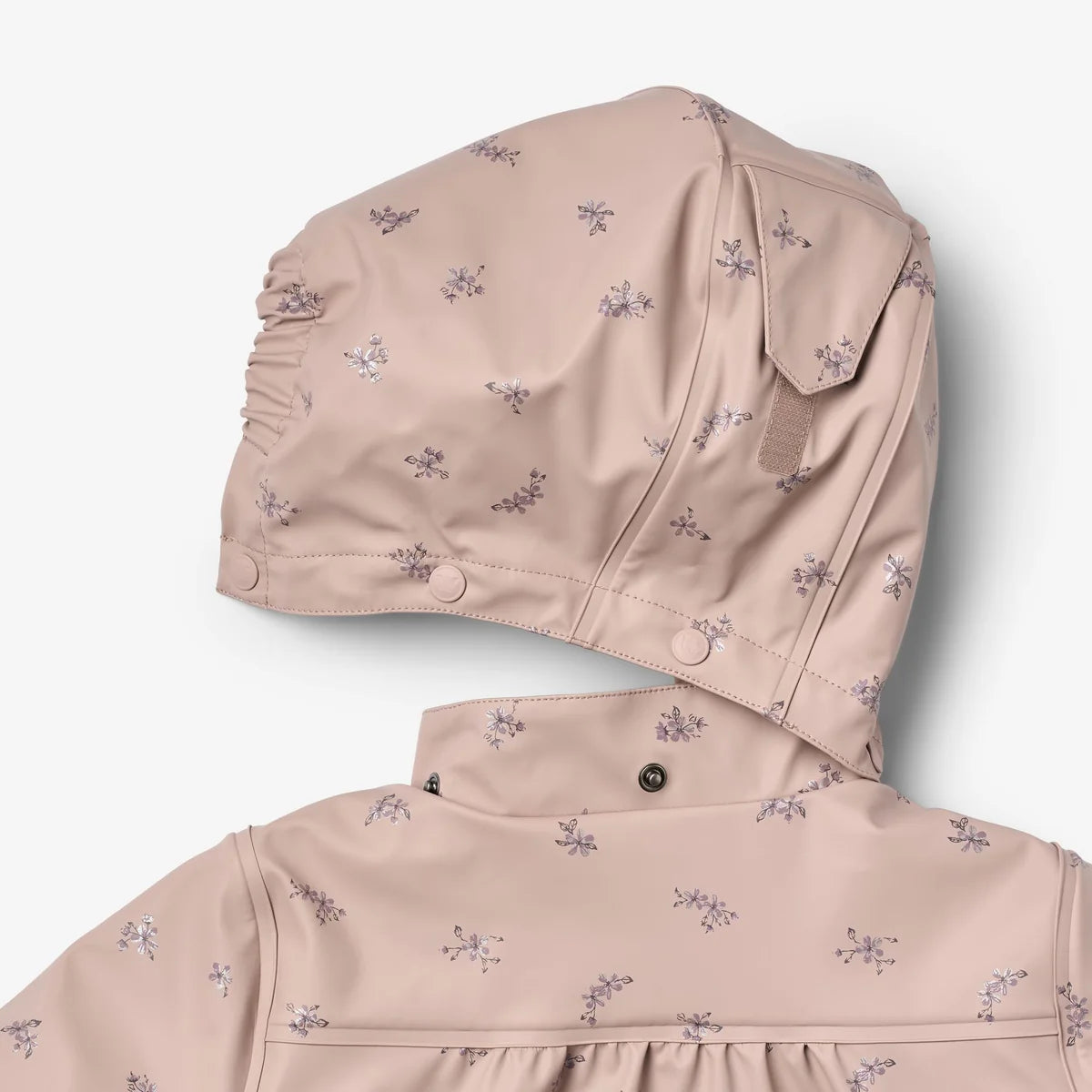 A close-up of a children's hooded raincoat in a dusty pink color with a small purple floral print, showing the hood and collar details.