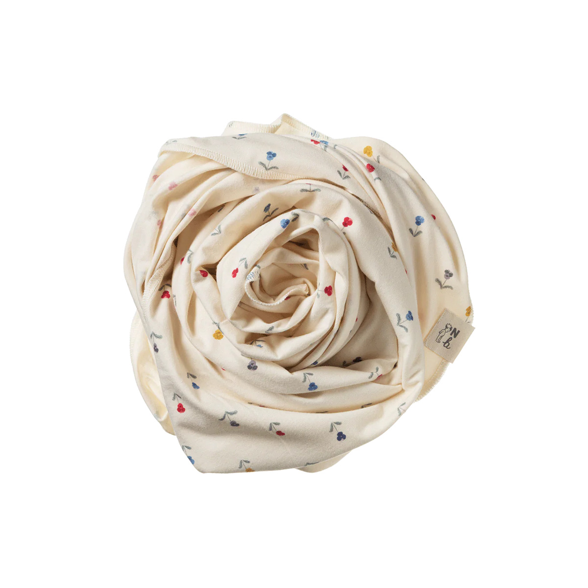 Rolled-up cream-colored fabric with small colorful patterns on a white background