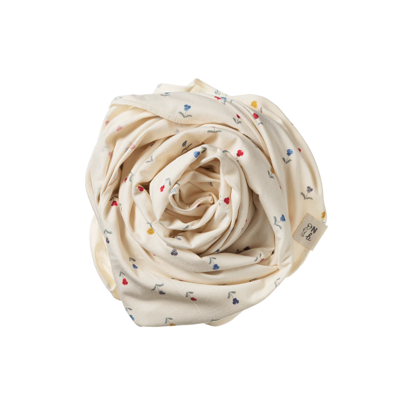 Rolled-up cream-colored fabric with small colorful patterns on a white background