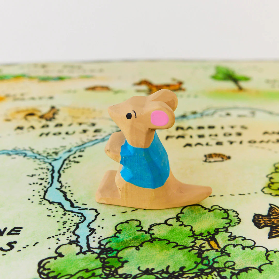 Wooden toy roo with a blue shirt on a white background