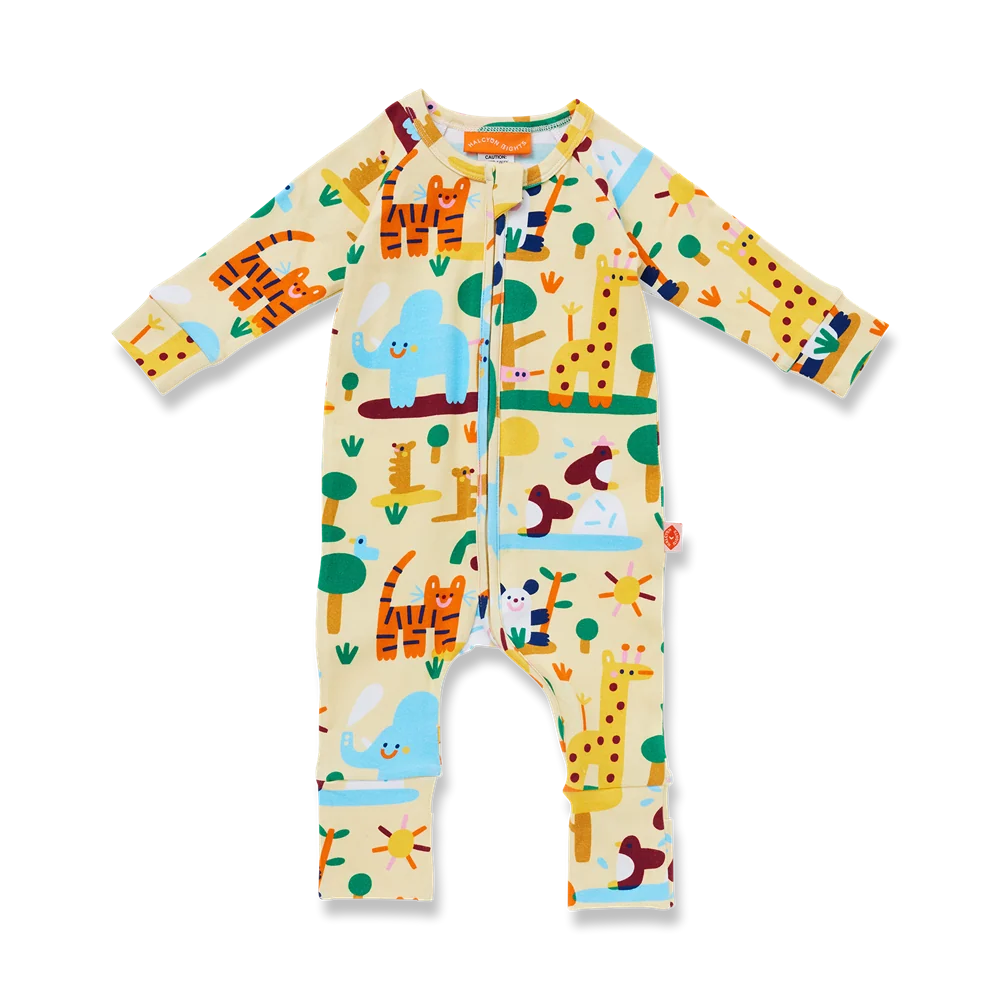 A baby long-sleeve footless one-piece romper with a colorful safari animal print on a cream background, featuring cartoon giraffes, tigers, an elephant, and trees.