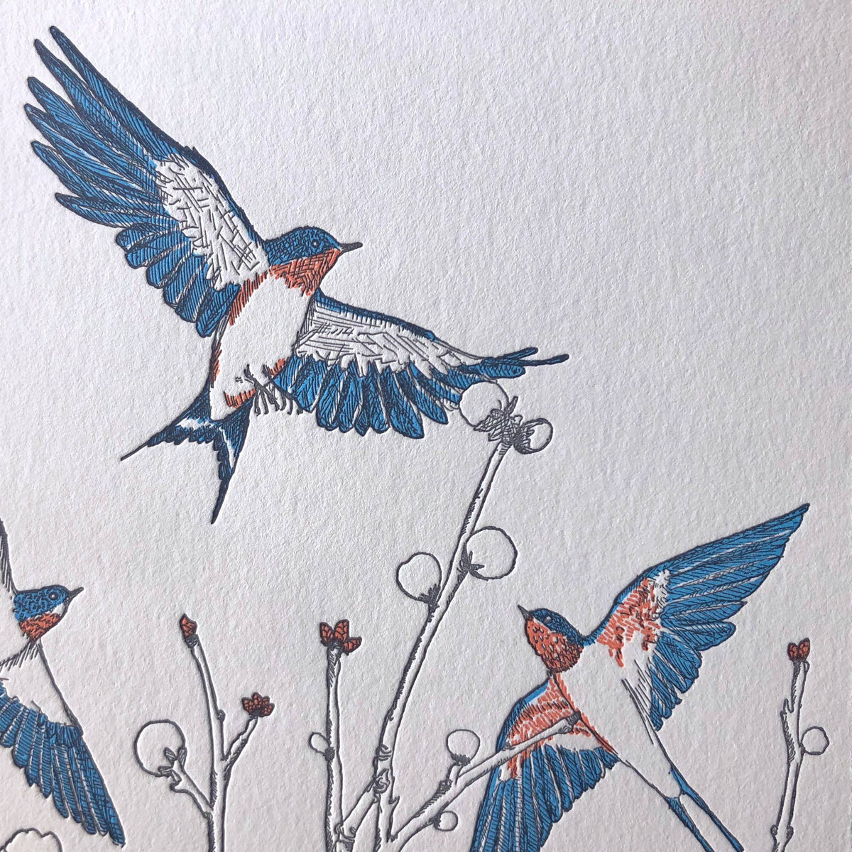 Embroidered design of birds on a white fabric background