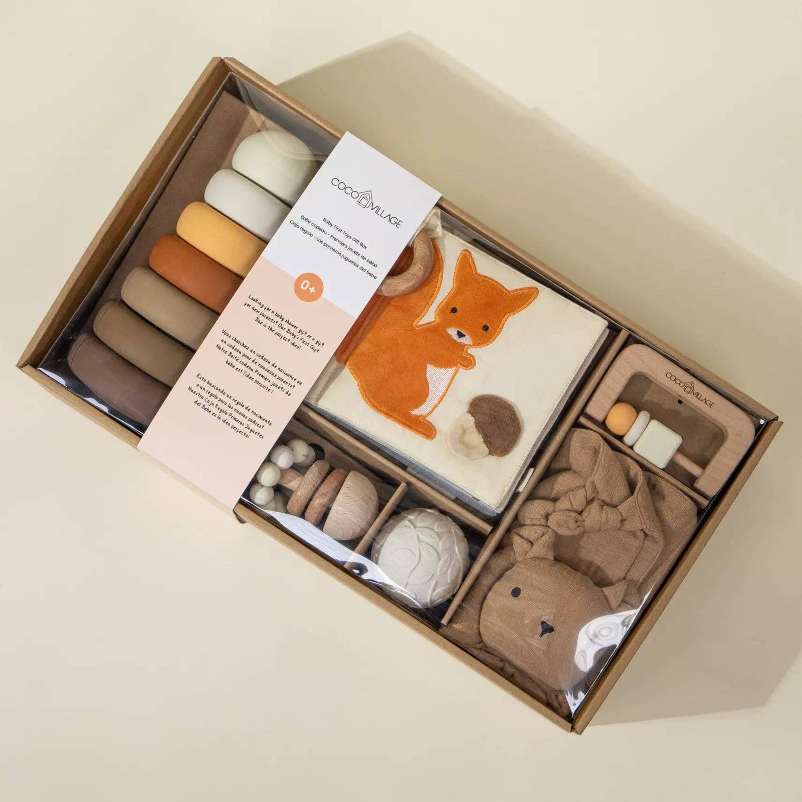 Baby product set with a fox design in a cardboard box on a beige background