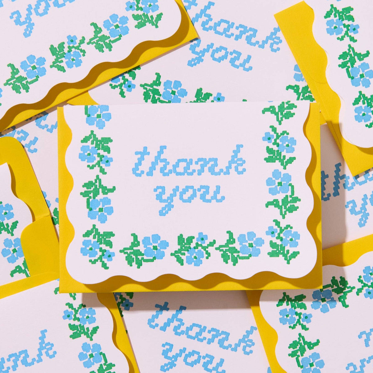 Set of 'thank you' cards with floral designs and yellow borders.
